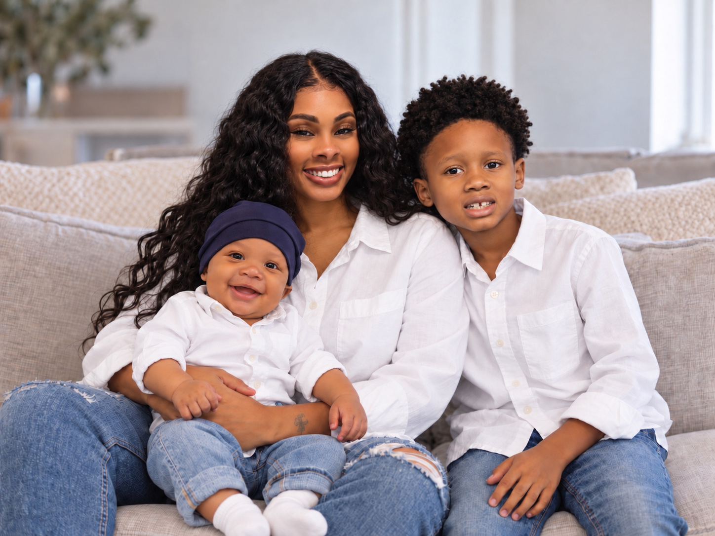Breanna smiling with her sons Kayson and baby Blue